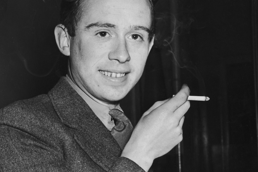 A black-and-white photograph of a young Scottish man smoking a cigarette.