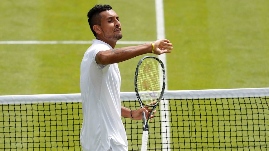 Nick Kyrgios gestures to the crowd during Wimbledon