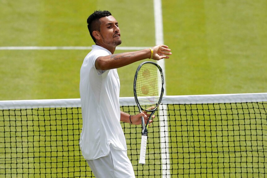 Nick Kyrgios gestures to the crowd during Wimbledon