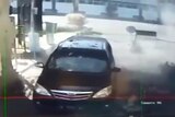 CCTV images show the moment of an explosion next to a car at a security post