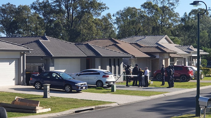 Police outside a house in suburban Brisbane