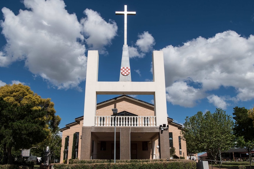 The front of a Croatian church featuring a cross.