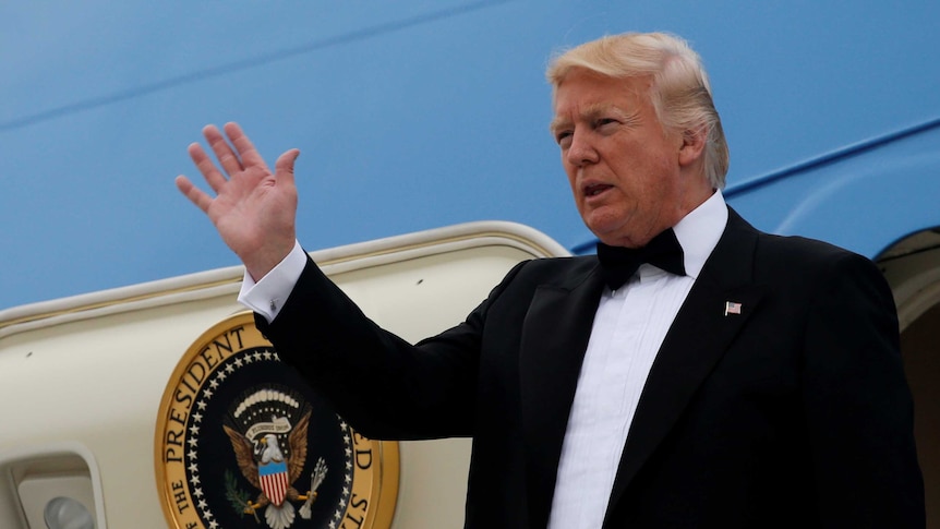 Donald Trump in black tie emerging from Air Force One