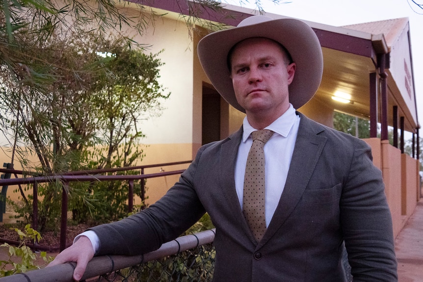 A man in a suit and cowboy hat.