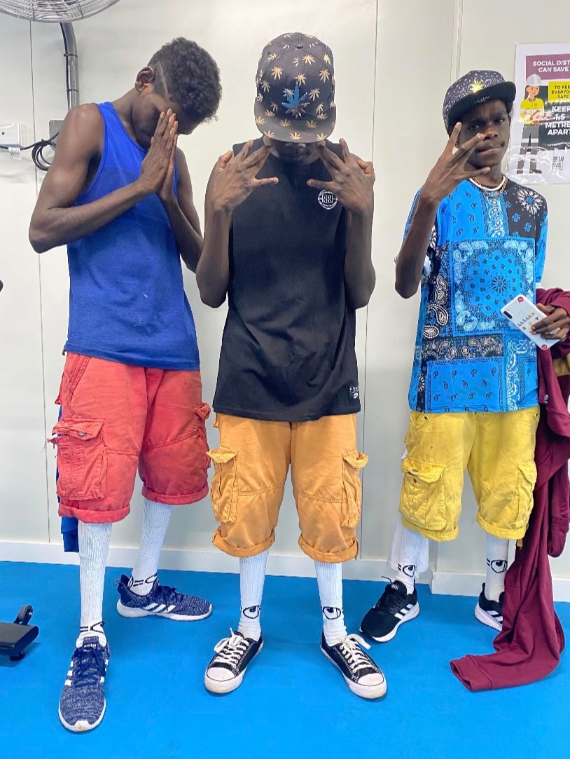 Three Groote Eylandt boys posing in shoes donated by Gold Coast charity