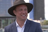 Steven Miles wearing a hat and smiling