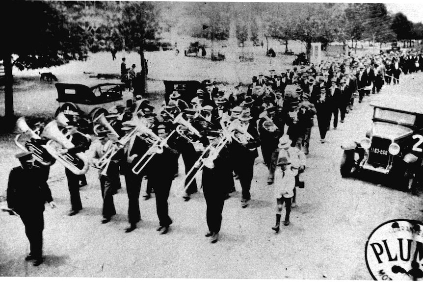 The Kurri pipe band leading the funeral procession for Norman Brown