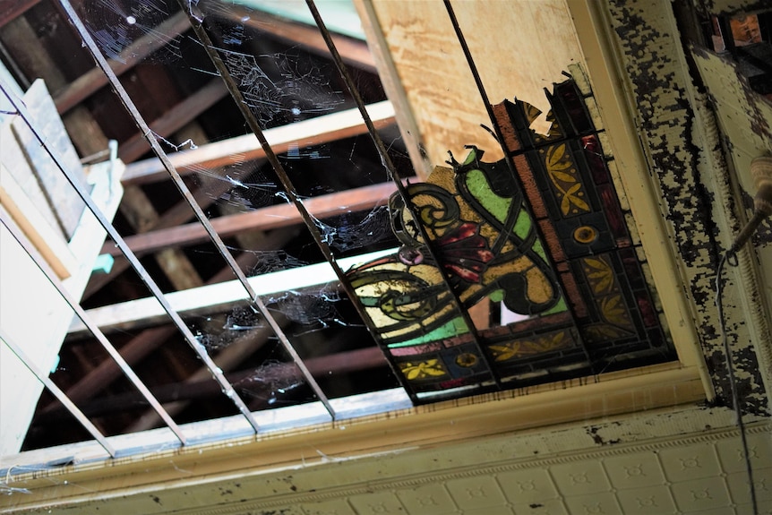 Damaged stained glass window in Lamb House in Kangaroo Point
