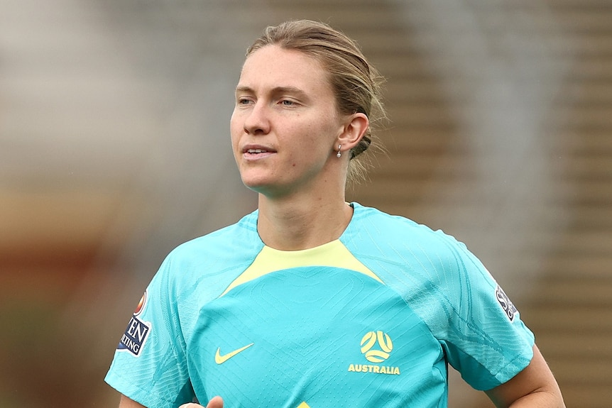 Clare runs in a blue jersey during training.