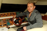 Gold Coast businessman Vitali Roesch sits in a yacht.