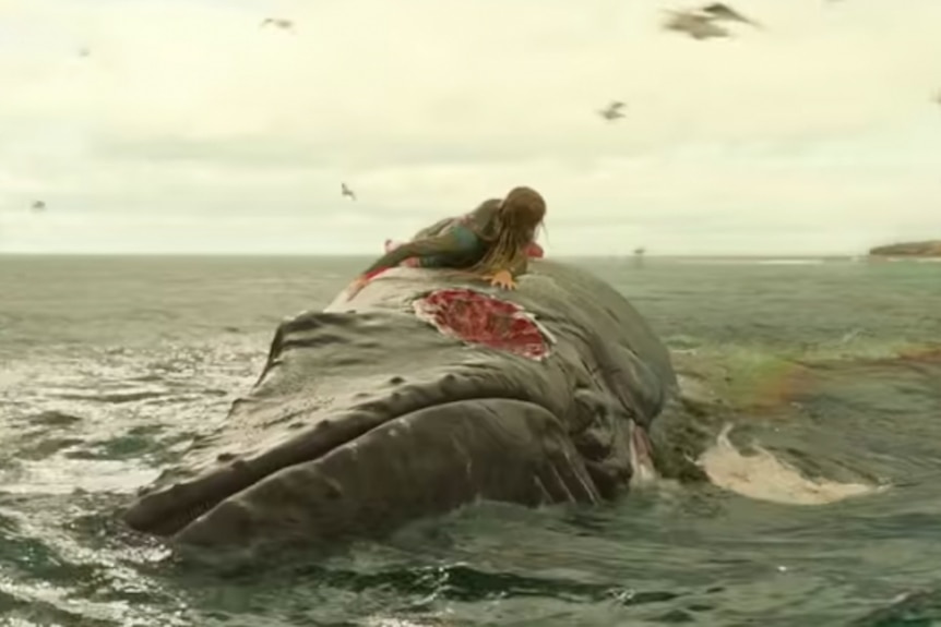 Actor on a whale in the ocean.