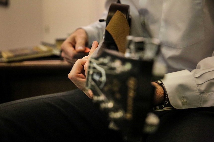 Tony Burke plays his favourite guitar during a lunch break at Parliament.