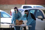 Medical workers in PPE at a Osborne Park COVID drive through clinic.