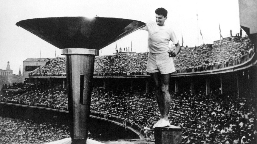 Ron Clarke lights the Olympic Torch at the opening ceremony of the 1956 Melbourne Olympic Games.