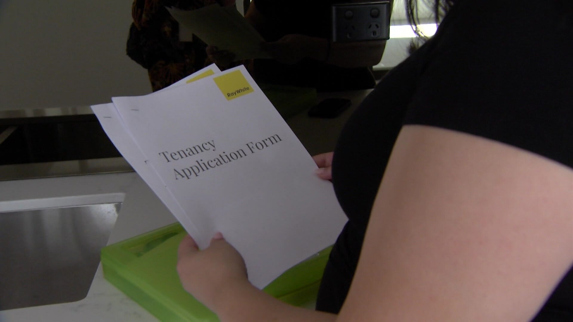 Woman holding Tenancy Application Form