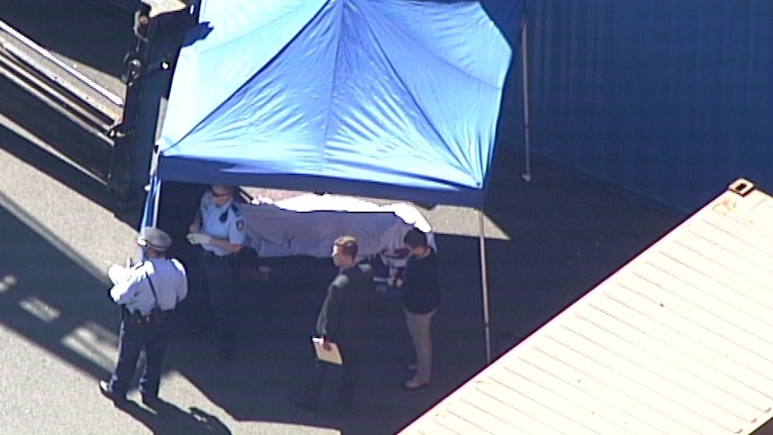 The worker covered by a sheet after the accident.