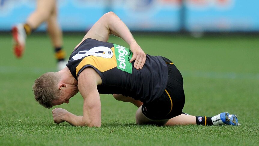 Down and out ... Jack Riewoldt holds his back after a heavy fall