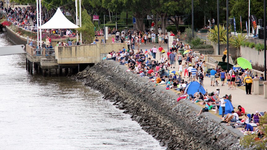 People begin to gather along the edge of the Brisbane River in readiness for Riverfire.