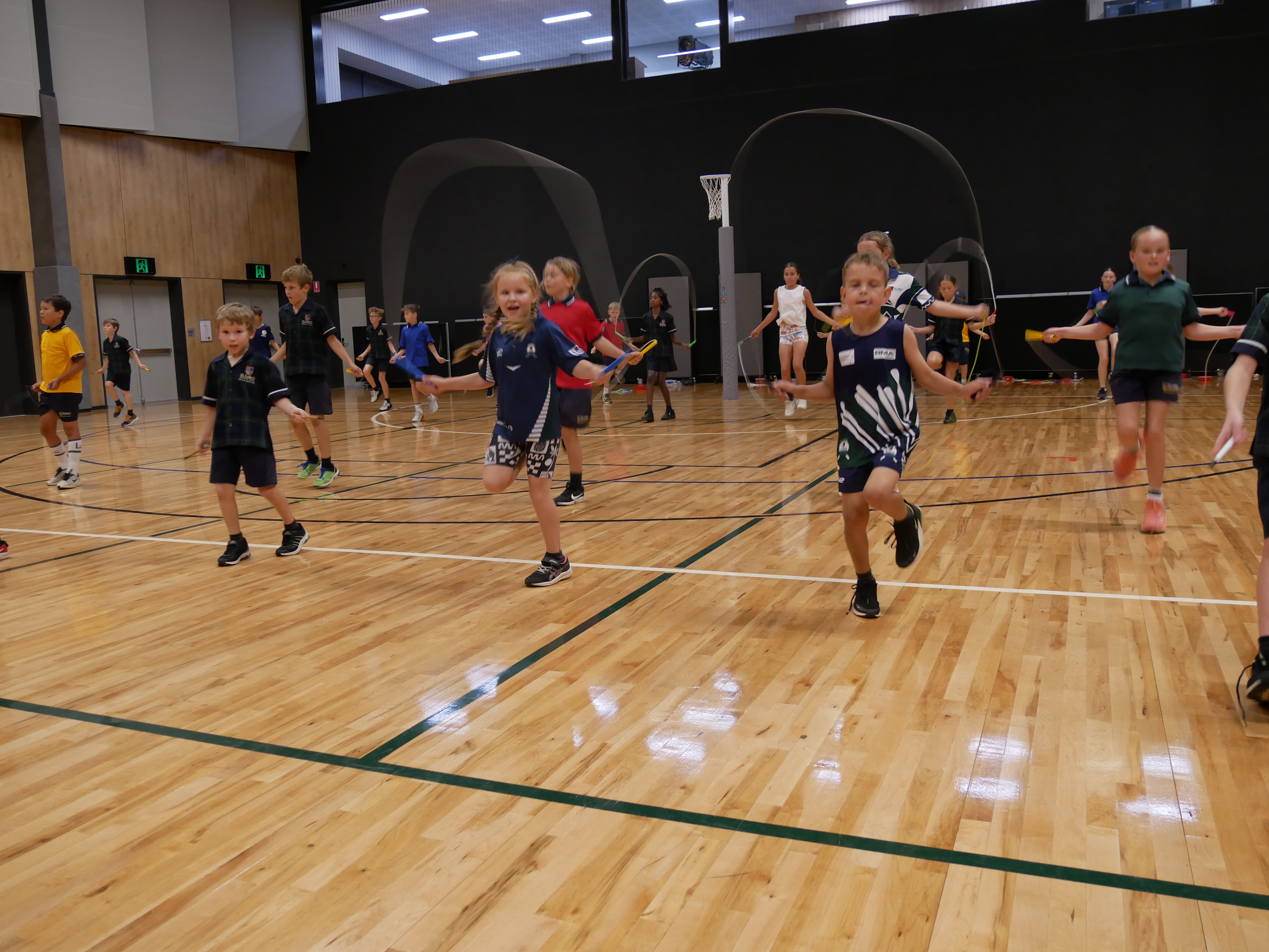 Lines of students skipping in a school gym