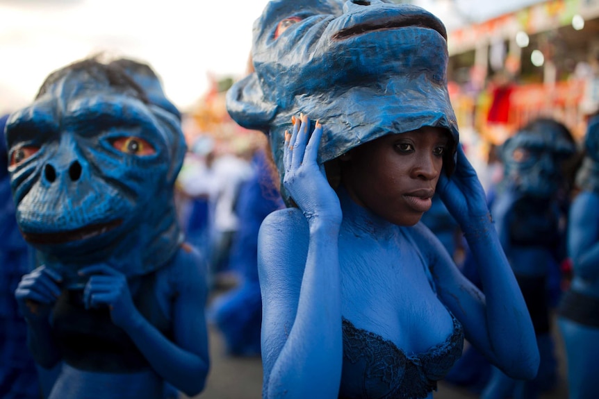 Performers in brightly coloured handmade costumes and body paint take part in Haiti's carnival parade