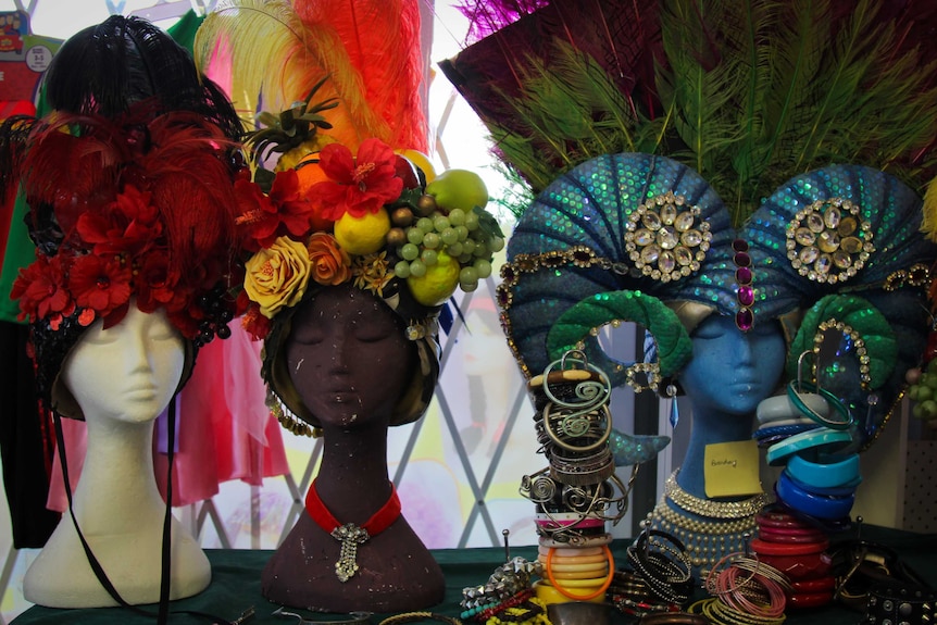 Three Priscilla headdress' on mannequins.