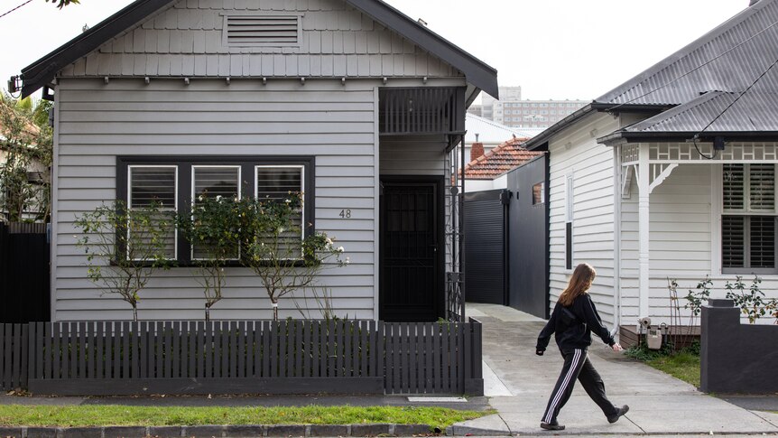 Someone walks past a Melbourne house.