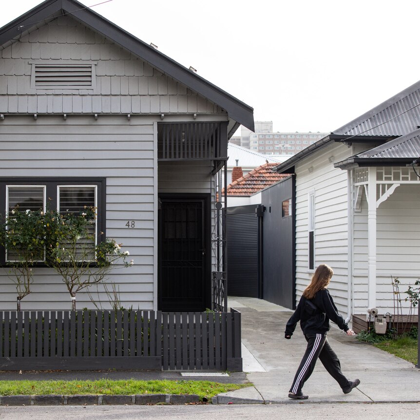 Someone walks past a Melbourne house.