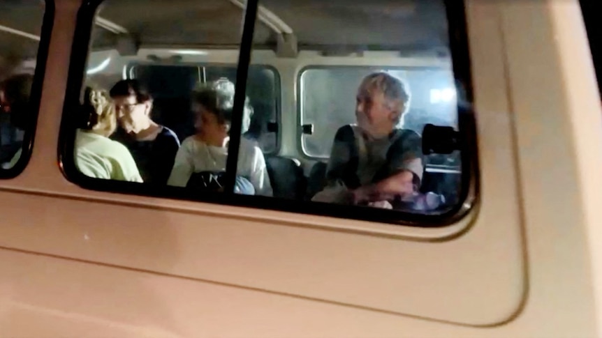 Several women visibile in a van.