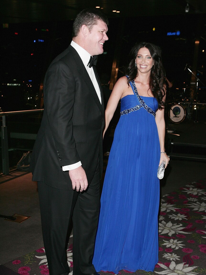 James and Erica Packer on red carpet in formal attire 