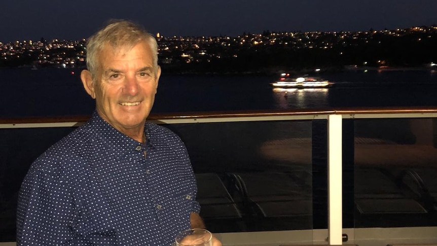 Ray Daniels enjoying a drink on the balcony of a cruise ship