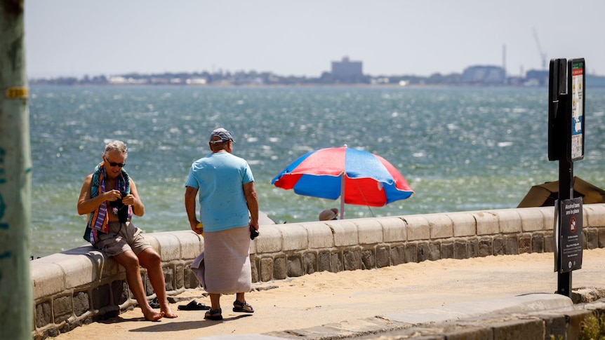 Two men next to a beach