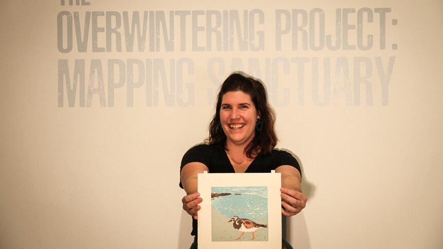 Emma-Lee Crane holds just one of hundreds of prints of birds