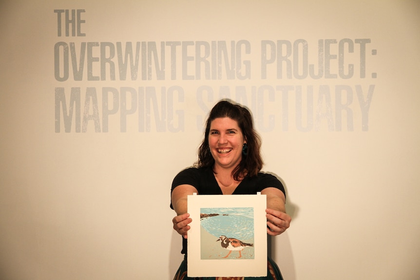 Emma-Lee Crane holds just one of hundreds of prints of birds