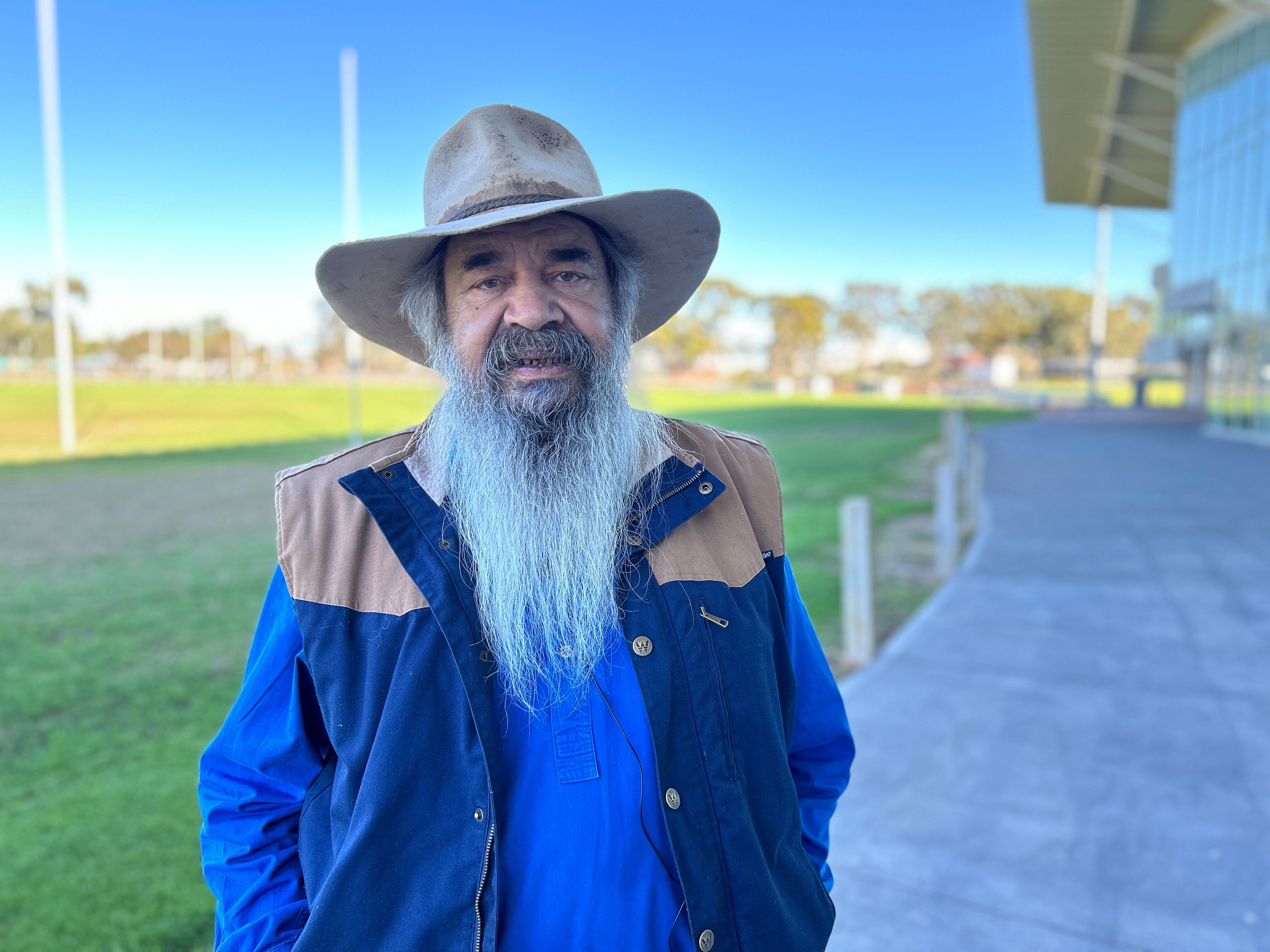 A man with a hat on and a beard