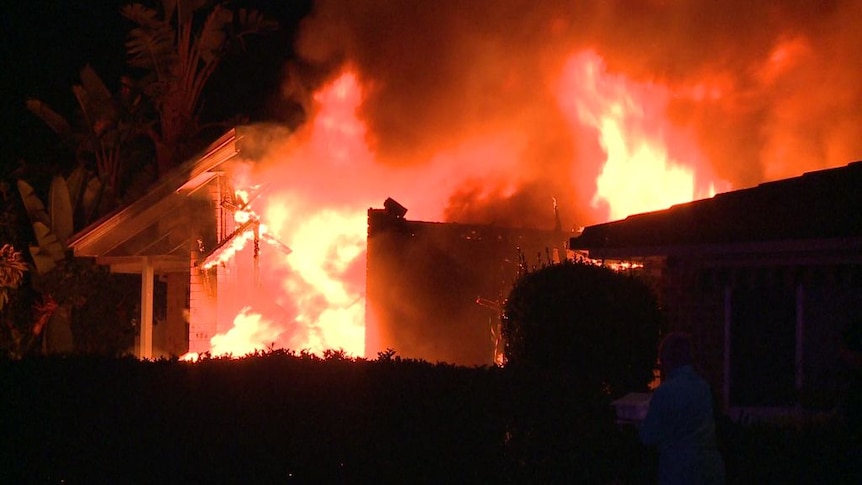 A house engulfed in intense flames.