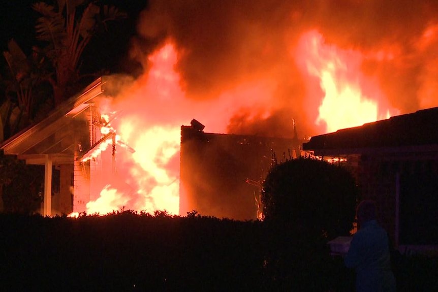 A house engulfed in intense flames.