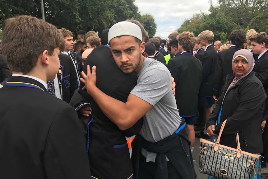 A young Muslim man embracing one of the students