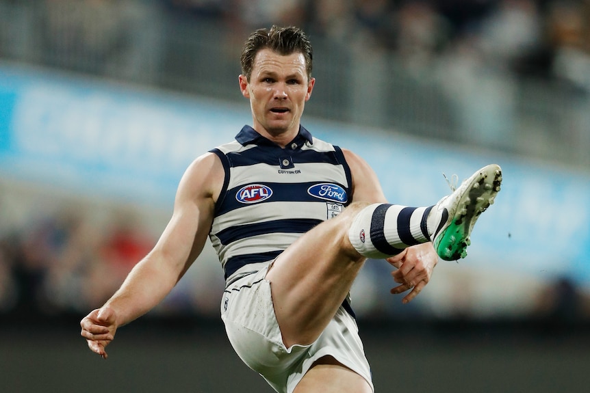 Patrick Dangerfield concentrates as he kicks the football