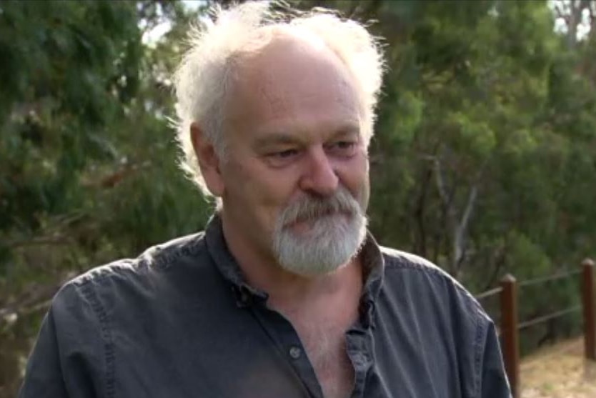 Terry standing in a vineyard.