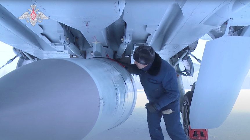 An airman checks a Russian Air Force MiG-31 fighter jet prior a flight with Kinzhal hypersonic missile.