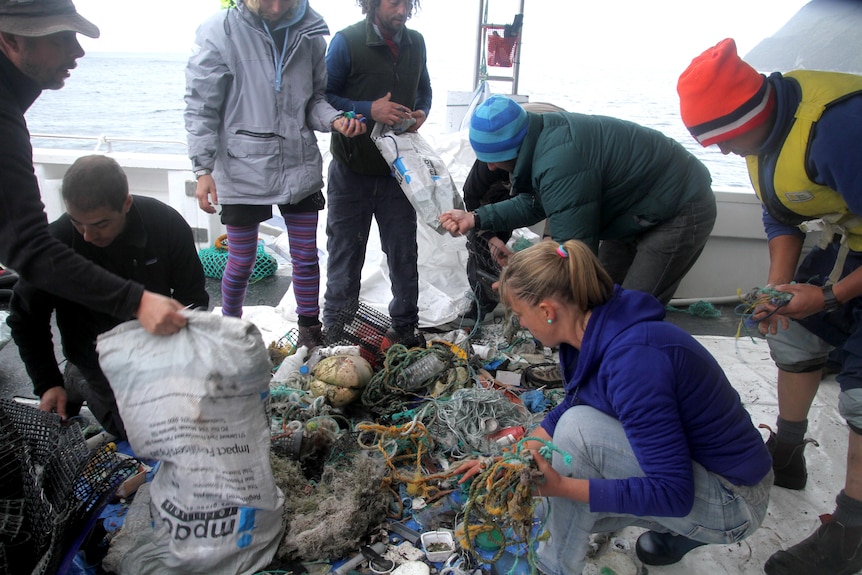 Ula Majewski picks up rubbish recovered from Tasmanian beaches
