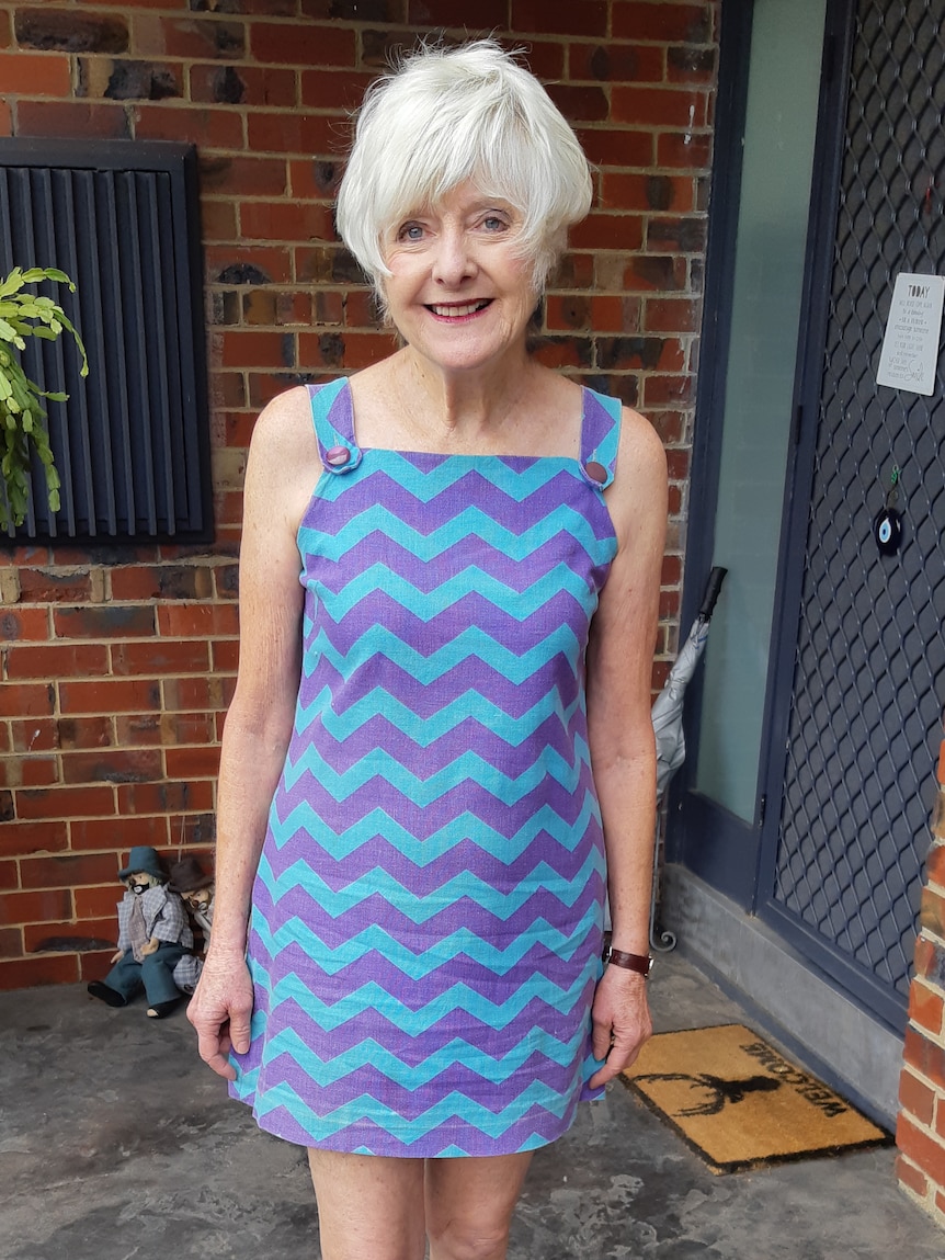 A woman wearing a blue and purple dress.