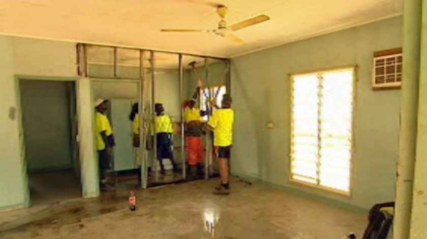 Workers refurbish a house