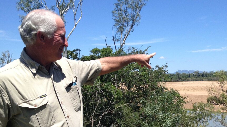 Don Heatley points out dry areas around the usually green Burdekin River near Home Hill.