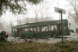 Emergency workers treat a victim of a bus explosion