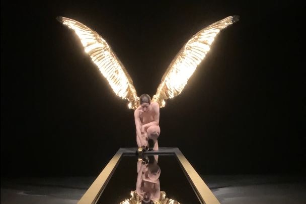 sculpture of a naked woman with wings