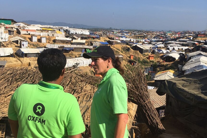 Two aid workers overlook a camp