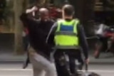 Hassan Khalif Shire Ali lunges at a policeman with a knife on Bourke Street.