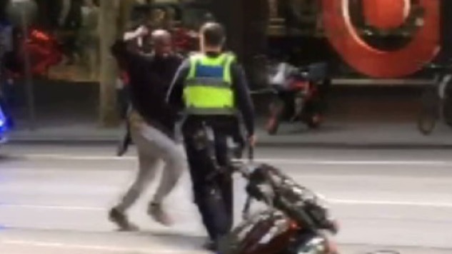 Hassan Khalif Shire Ali lunges at a policeman with a knife on Bourke Street.