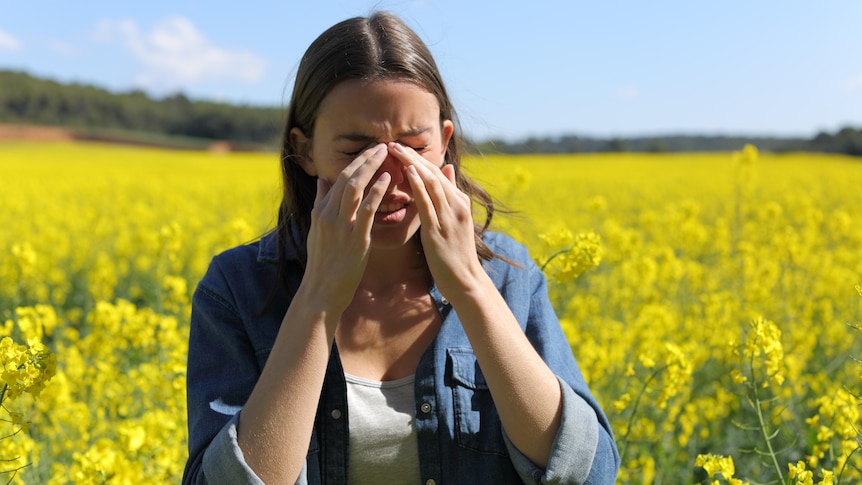 Woman sneezing from hay fever